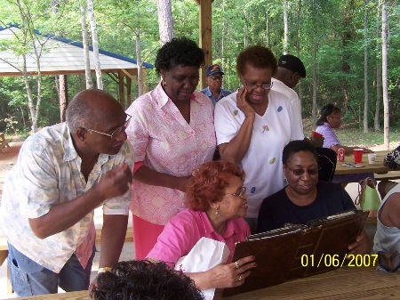 Roy L. Clark (Class of '57) enjoys viewing photos of RCTS students at the 2007 RCTS Bar-b-Que at a marina in LaGrange, GA